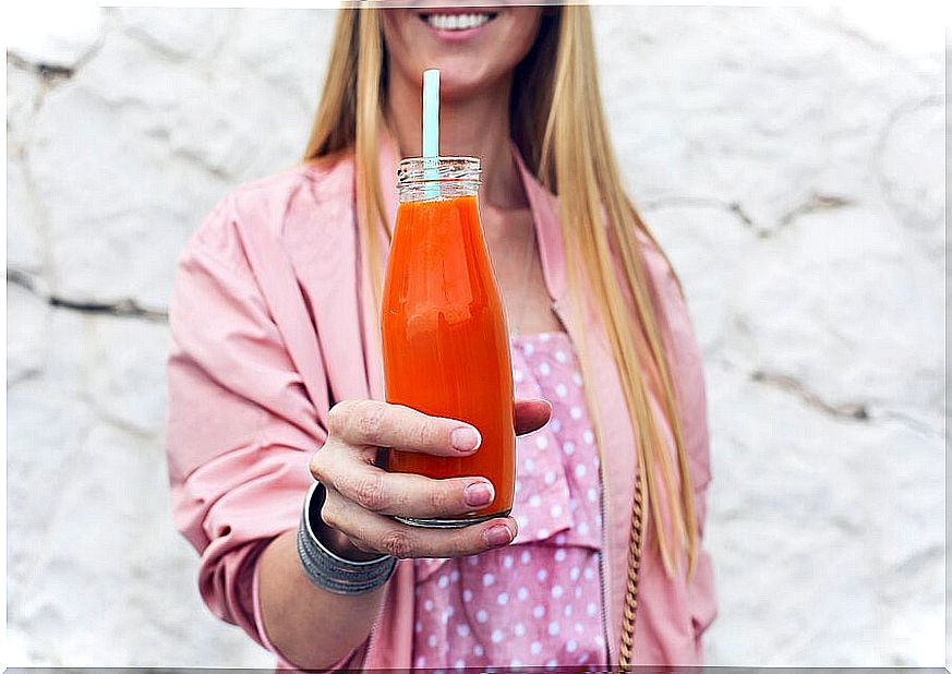 Woman drinking carrot smoothie