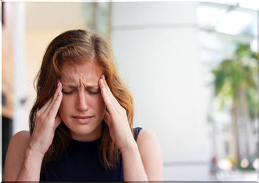 Woman with headache from anxiety.