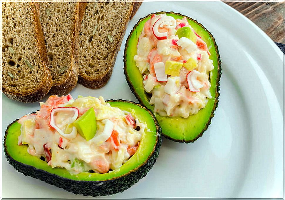 Avocado stuffed with surimi.