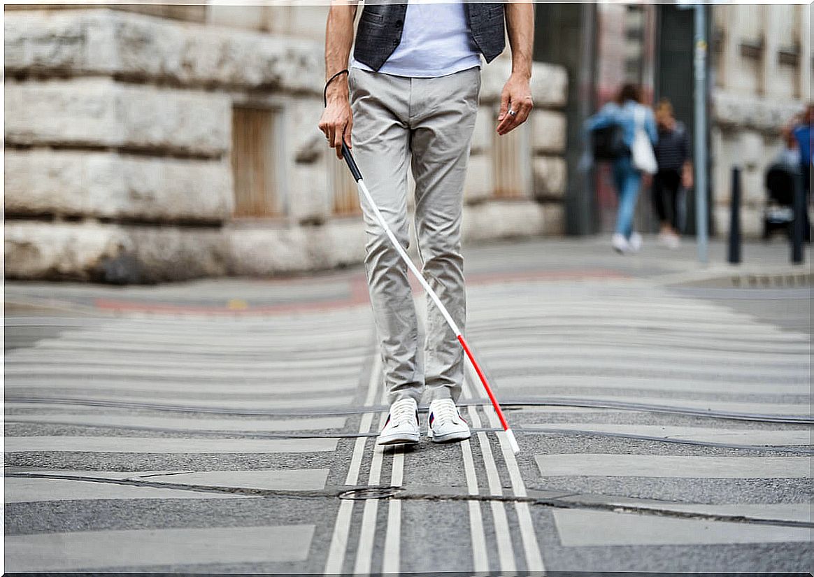 Blind man with white cane.