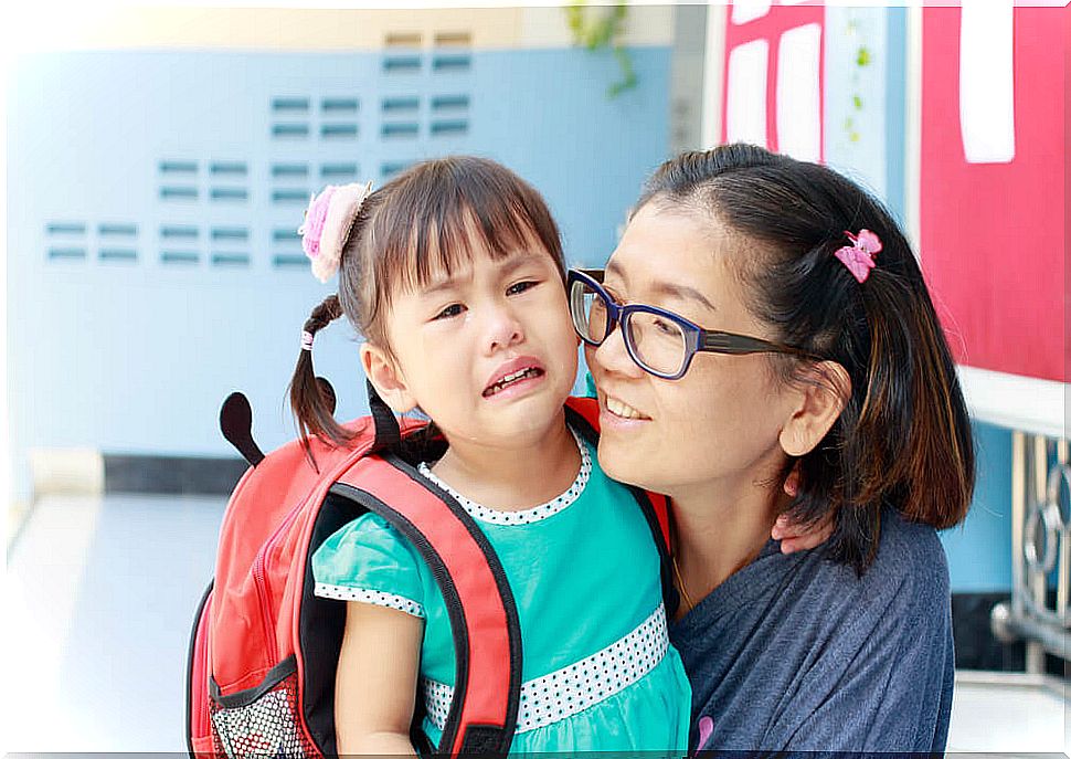 Mother accompanying her daughter to school.