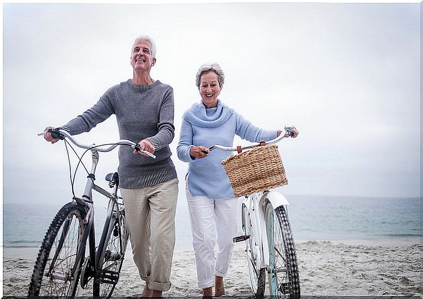 Older couple with bikes on the beach