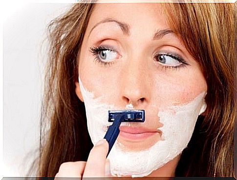 Woman with excess facial hair shaving