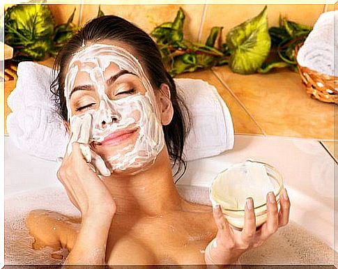 Woman applying a scrub to her face