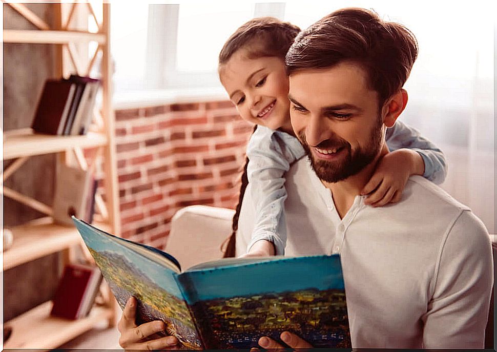 Father reading a book to his daughter.