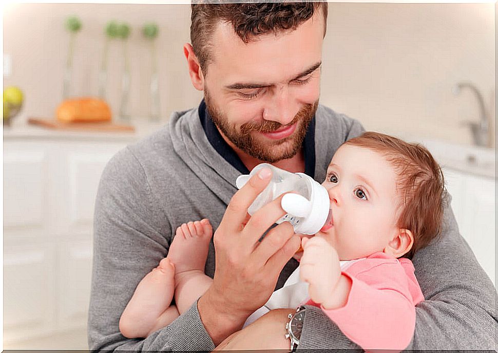 Father giving his baby a bottle.