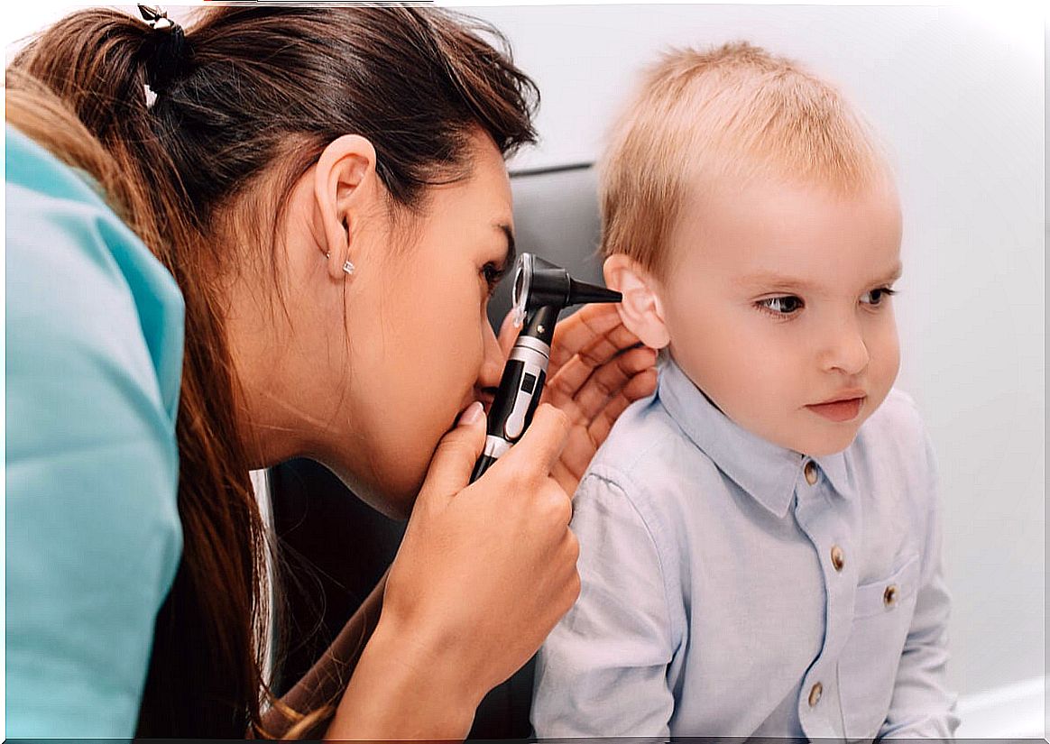 Pediatrician checks a child's ear.