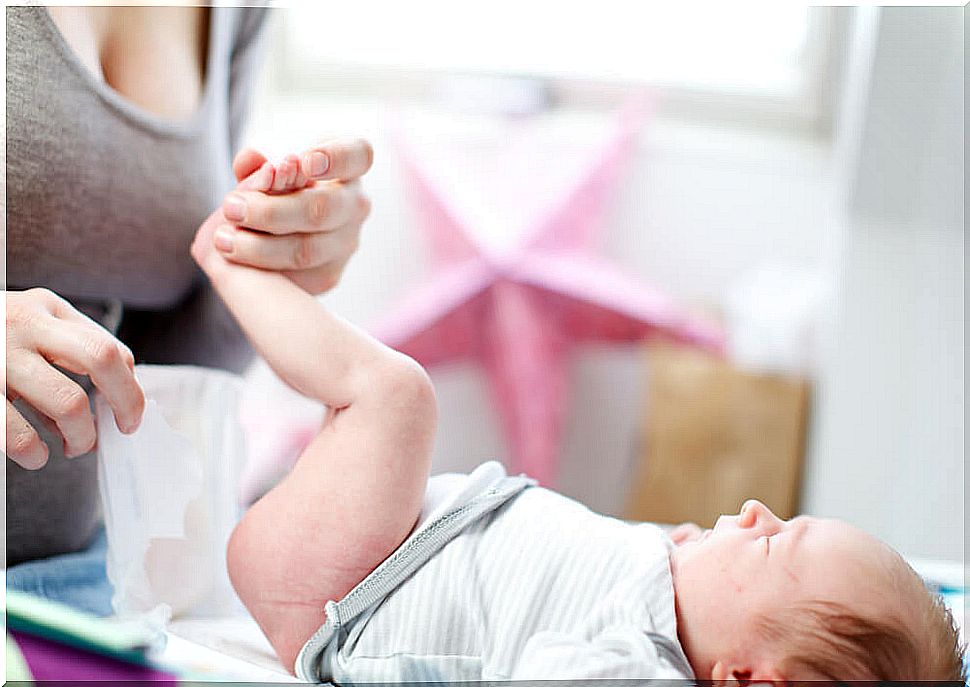 Mother changing a baby's diaper