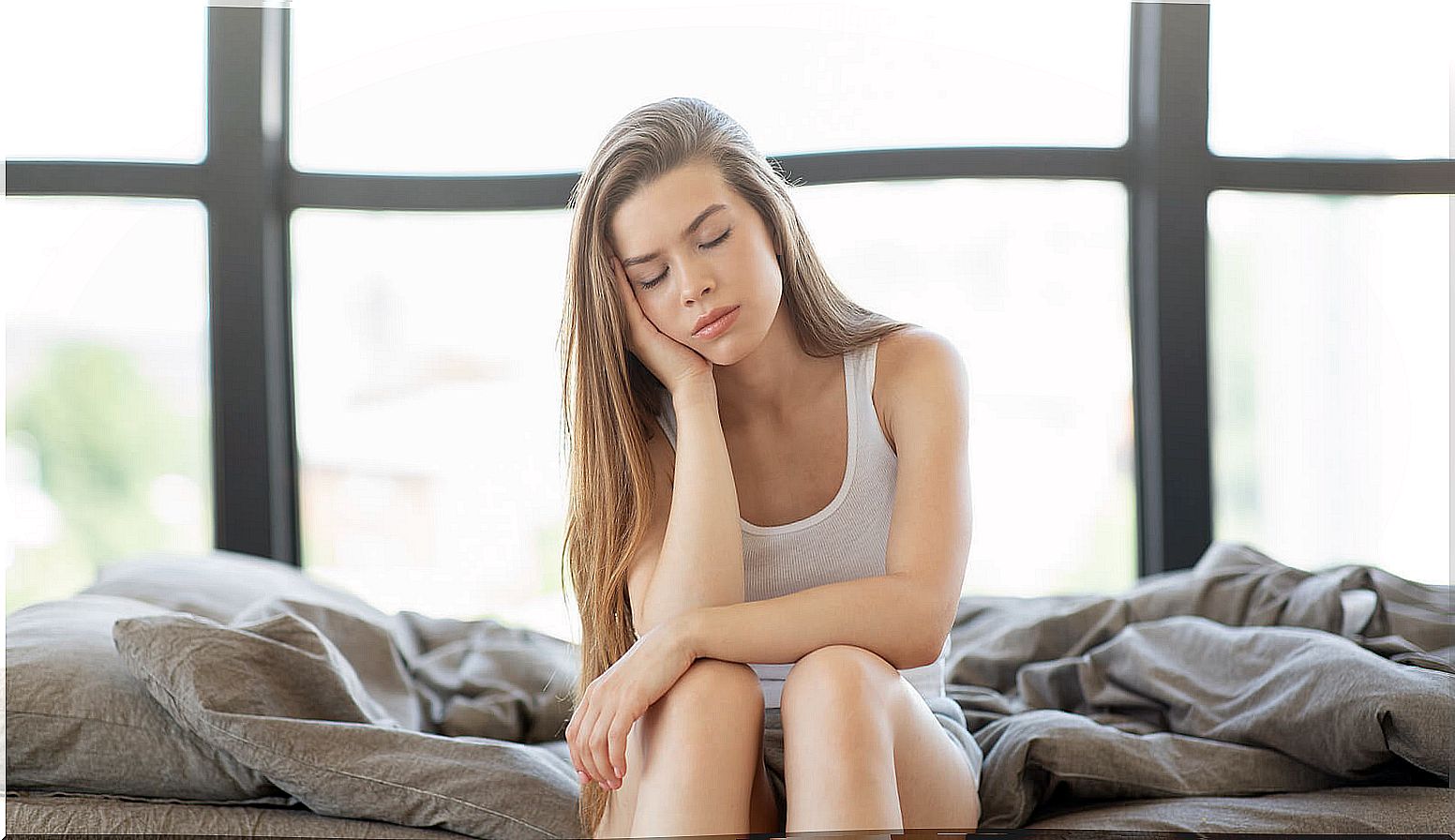 Tired woman in bed when waking up